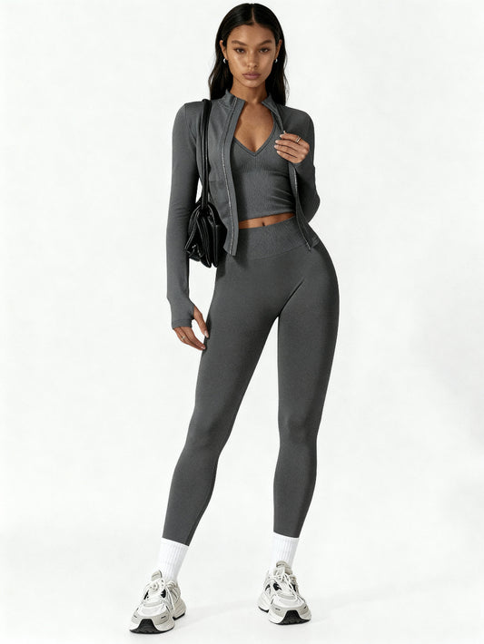 Woman wearing a gray athletic outfit on a white background