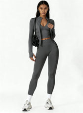 Woman wearing a gray athletic outfit on a white background