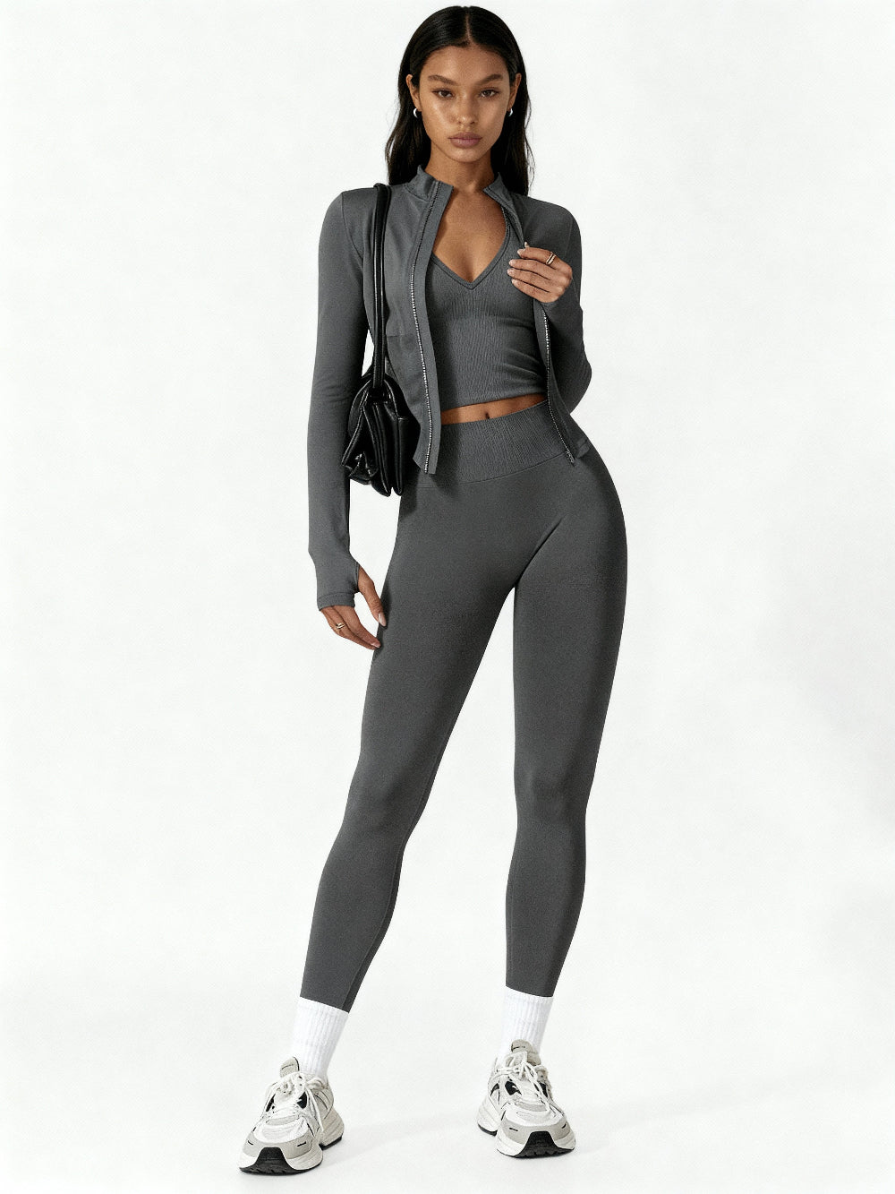 Woman wearing a gray athletic outfit on a white background