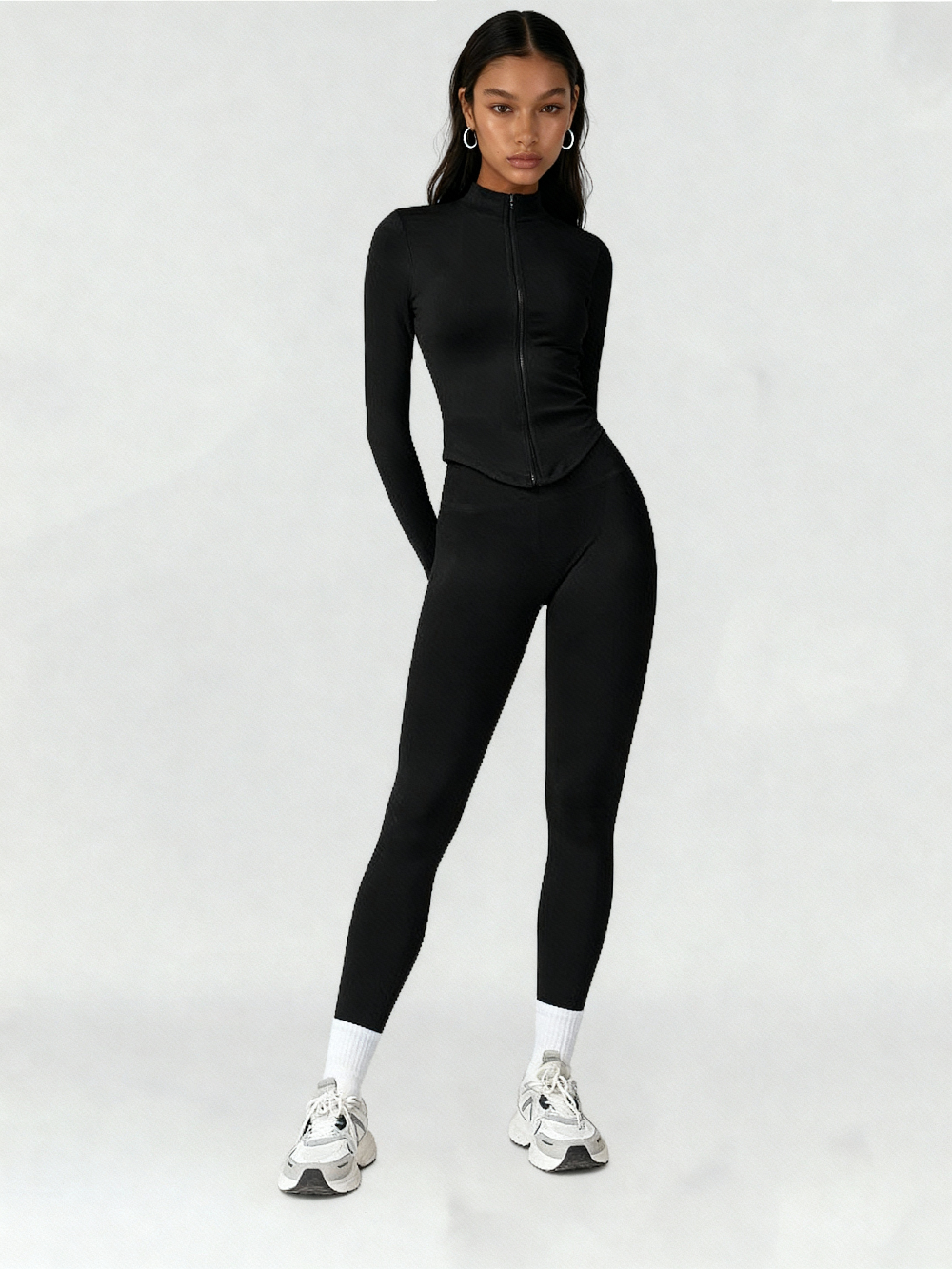 Person wearing a black athletic outfit on a white background